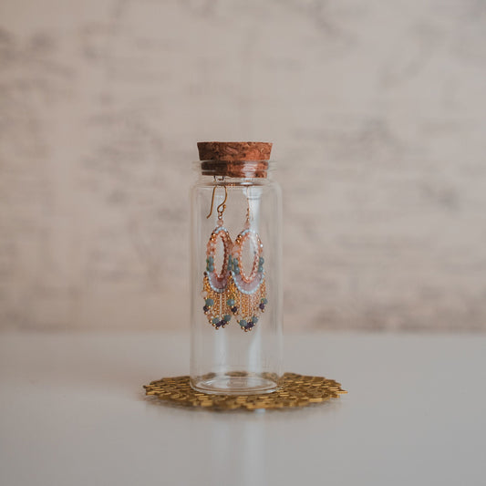 Decorative glass bottle with cork lid on a marble surface