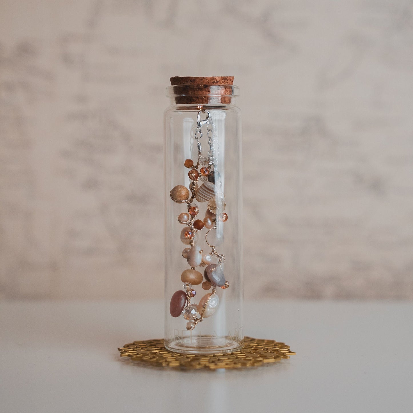 Glass jar with jewelry on a marble surface