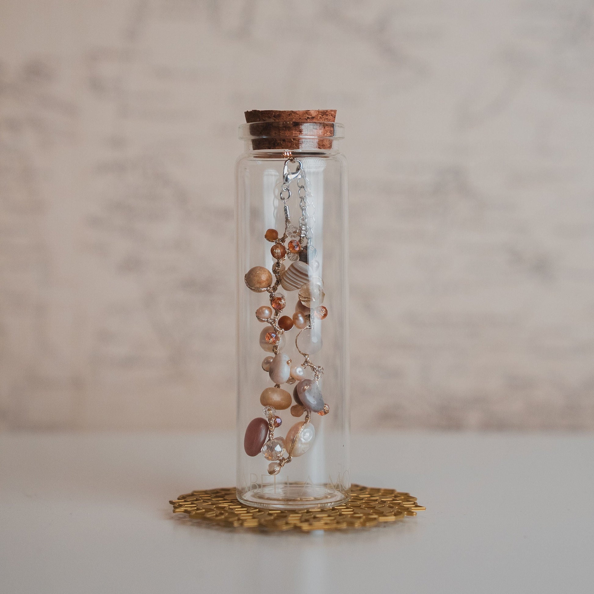 Glass jar with jewelry on a marble surface